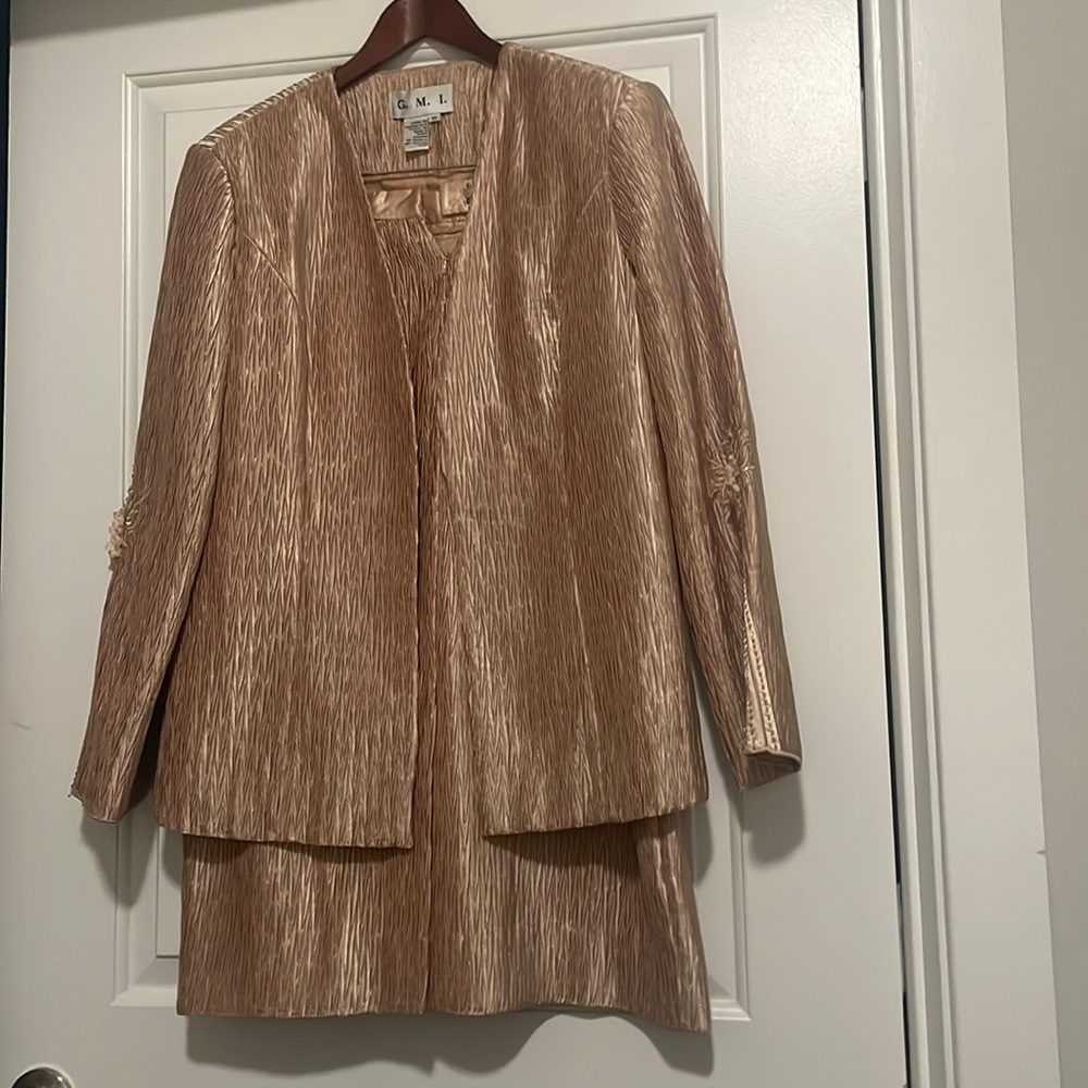 2Piece suit, SIZE 16, fully lined with a back slit. Detailed decor on sleeves.